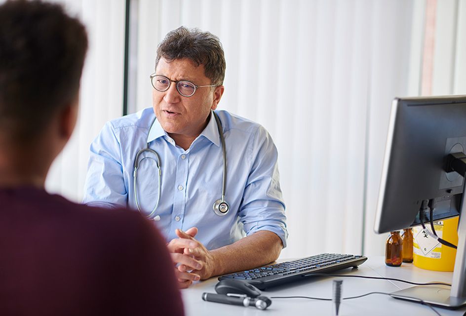 A GP talks to his patient.