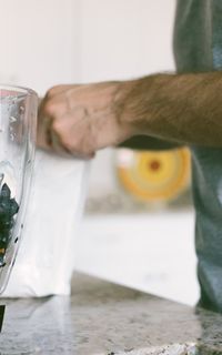 A man making a smoothie as part of a sports nutrition regime