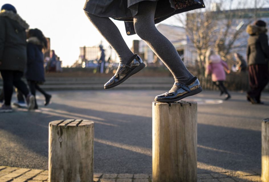 Child playing with playground equipment outside