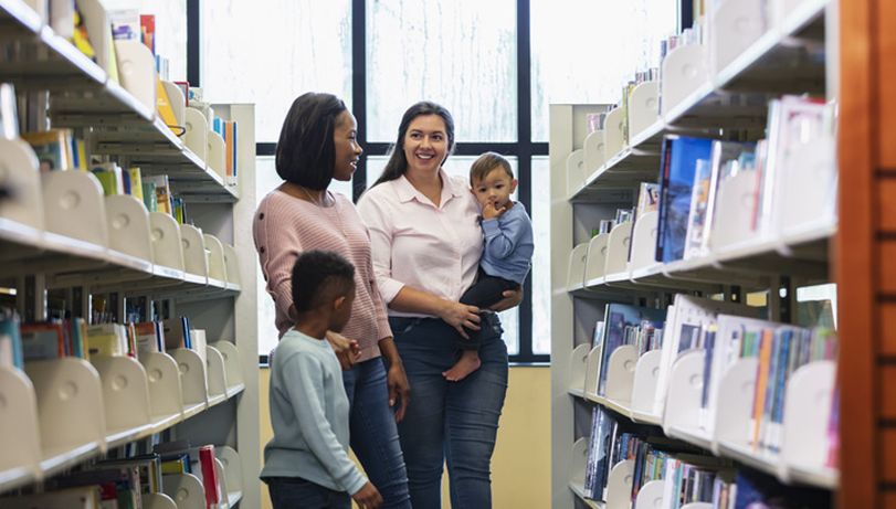 Photo of parents and their children in a library
