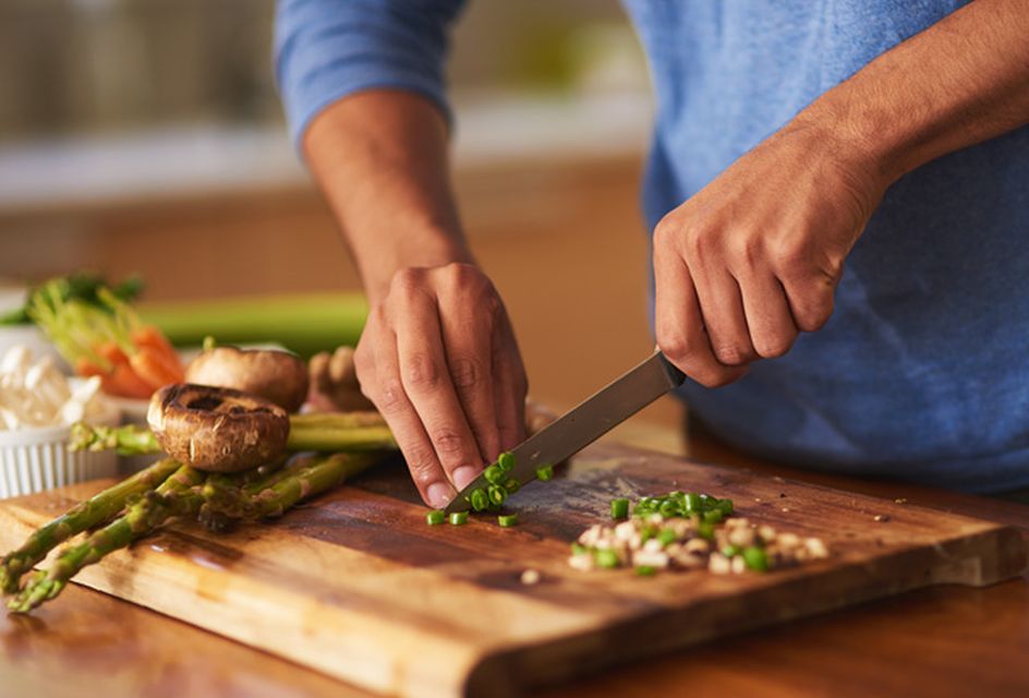 A man chopping ingredients for a healthy meal