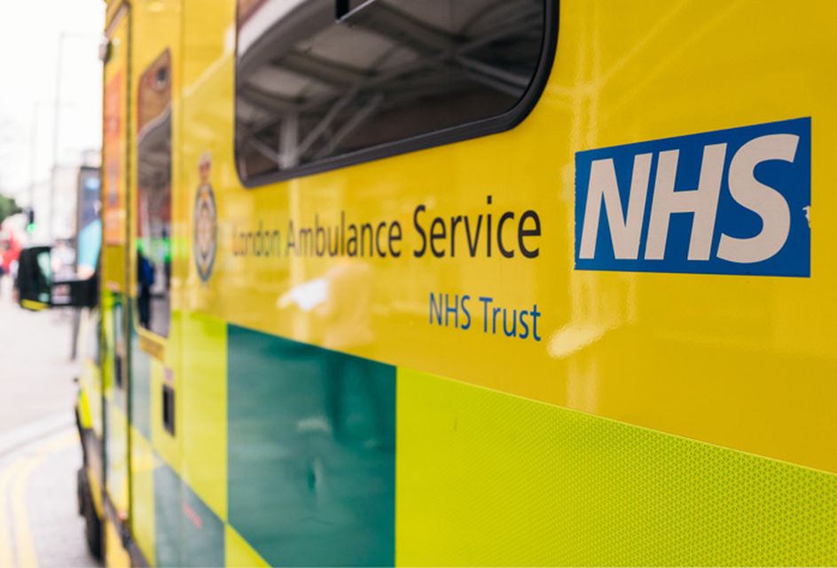 A close-up of an ambulance which has text reading "London Ambulance Service NHS Trust" and the NHS logo.