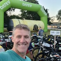 James McIerney, a white man with grey hair and blue eyes smiling.