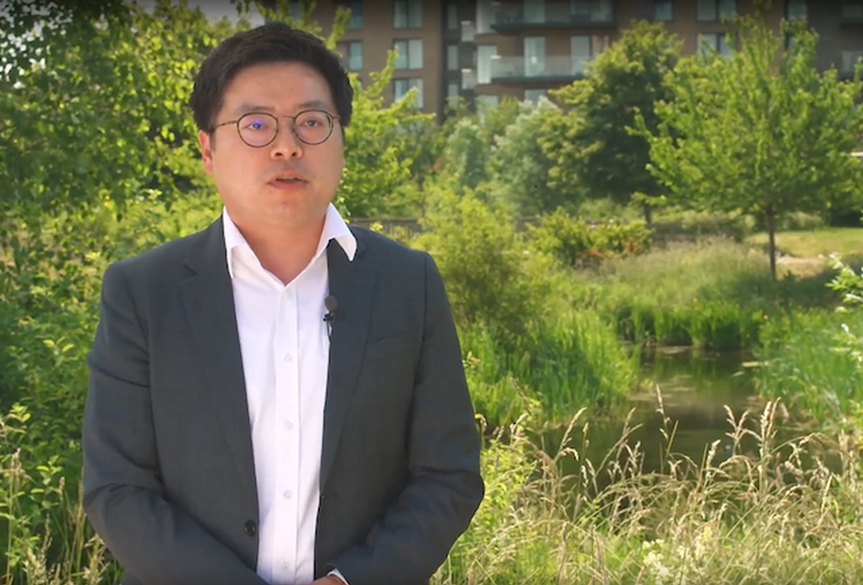 Michael Chang, an Asian man with short black hair. He wears glasses and a navy suit.
